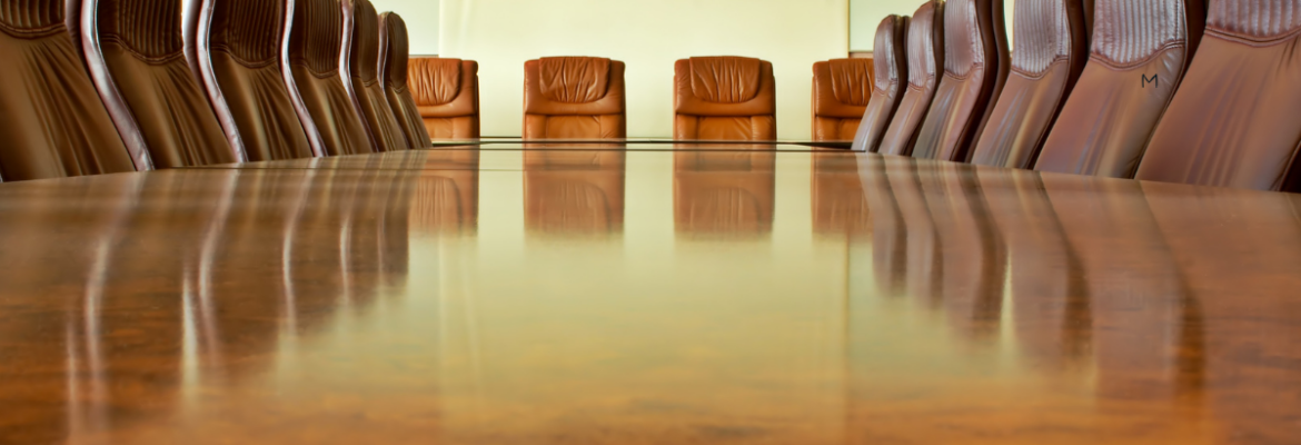 Empty boardroom table and chairs in a corporate office