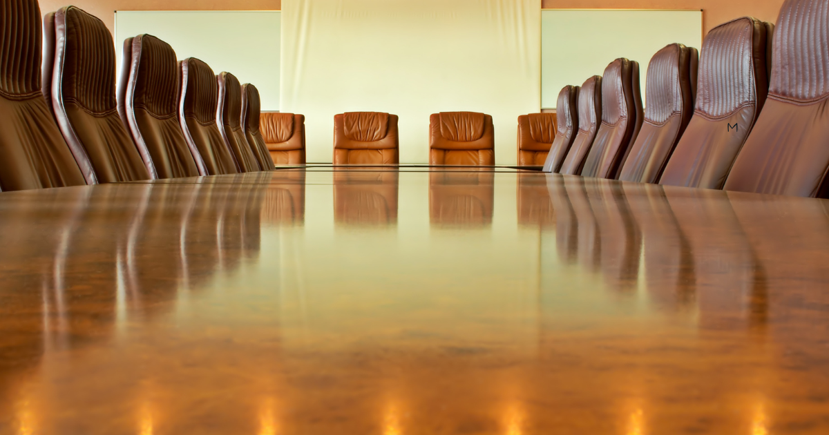 Empty boardroom table and chairs in a corporate office